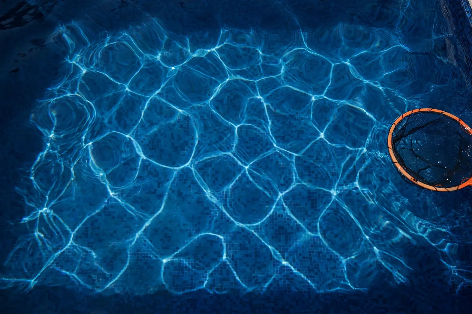 Looking down into crystal-clear deep pool water